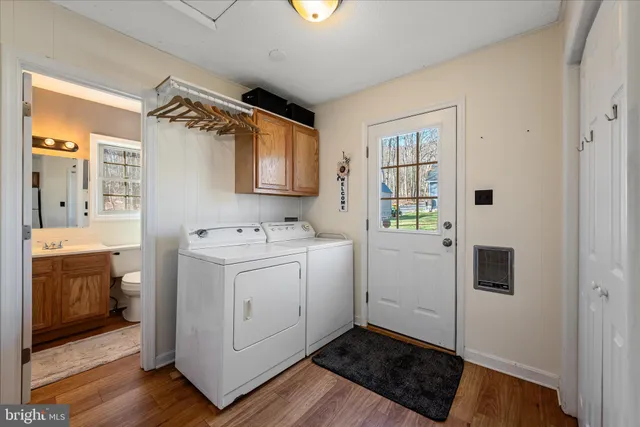 a bedroom with a bed a dresser and chair