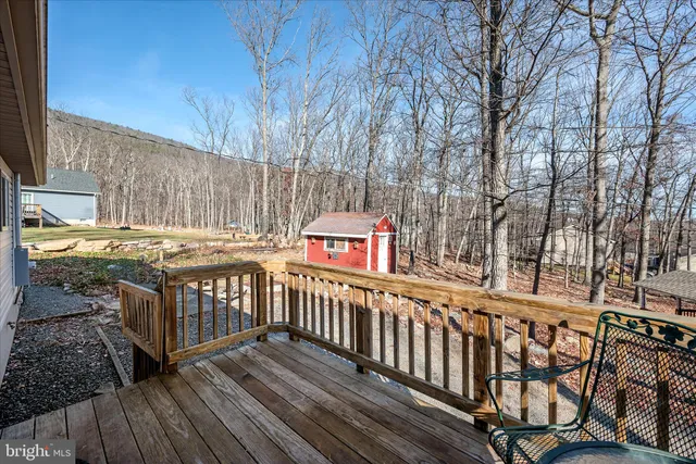 a view of roof deck with wooden fence and wooden fence