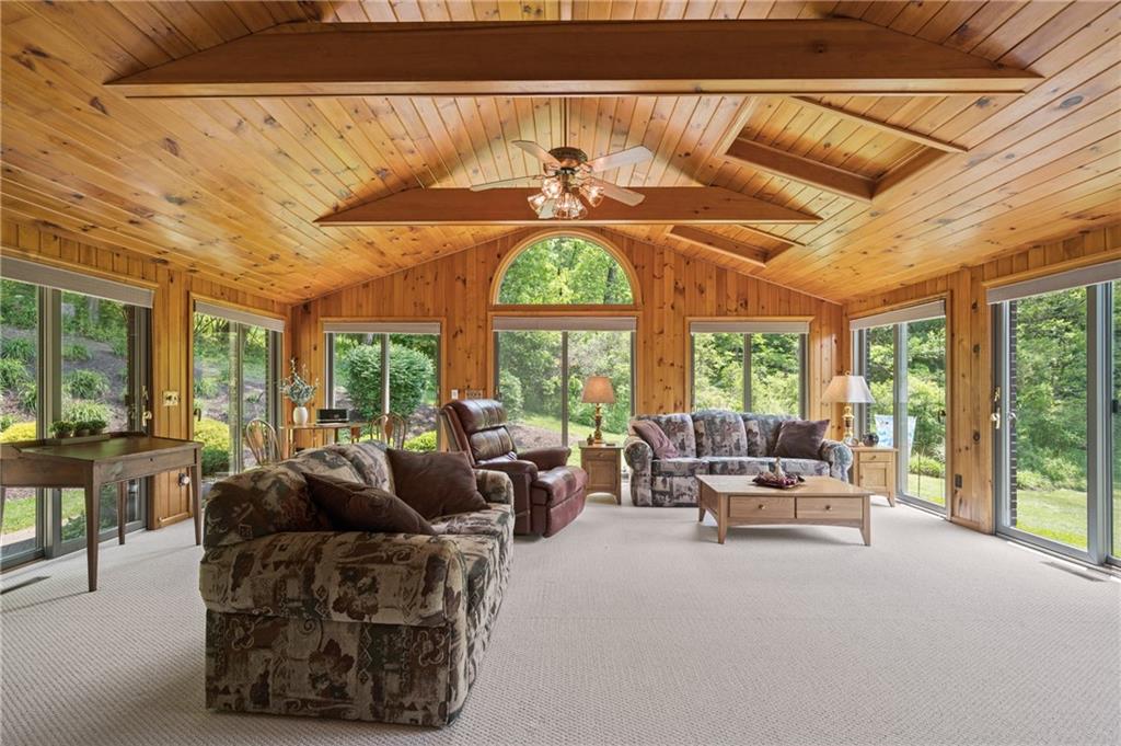 633 Martin Road Tarentum, PA 15084 - Photo 8 of 19 a living room with furniture a chandelier and a large window