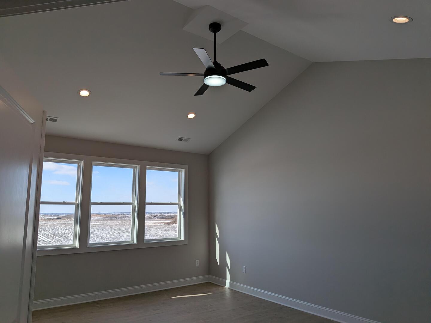 675 South Regulators Street Creston, IL 60113 - Photo 17 of 27 an empty room with a window and ceiling fan