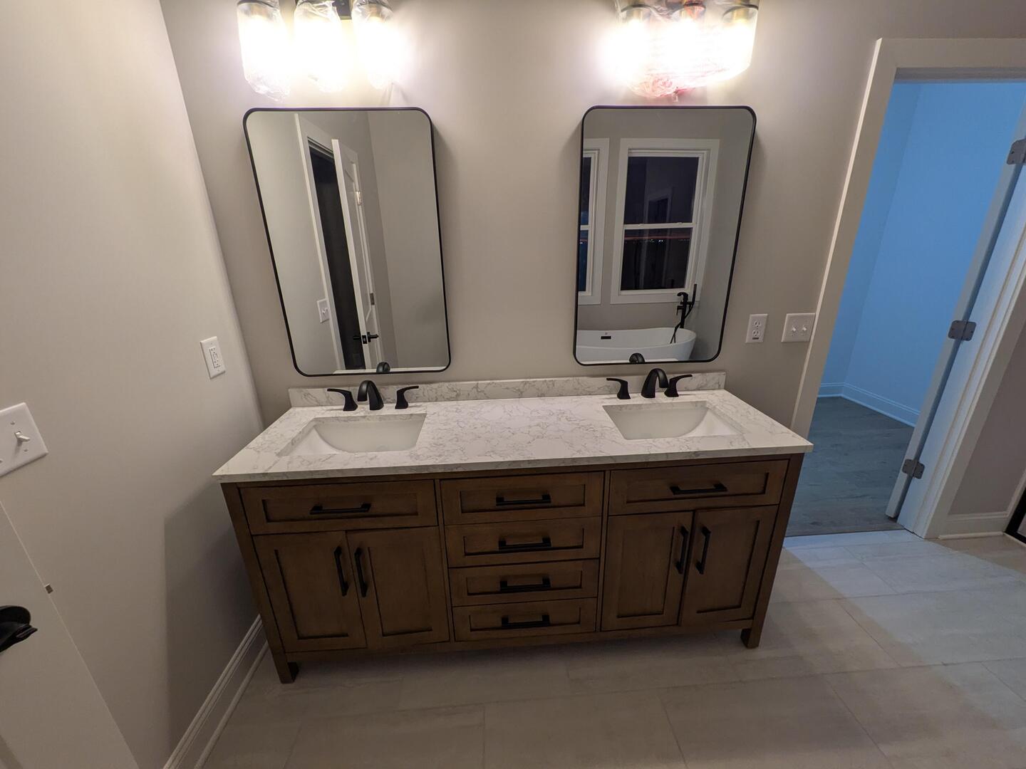675 South Regulators Street Creston, IL 60113 - Photo 21 of 27 a bathroom with a sink and a mirror