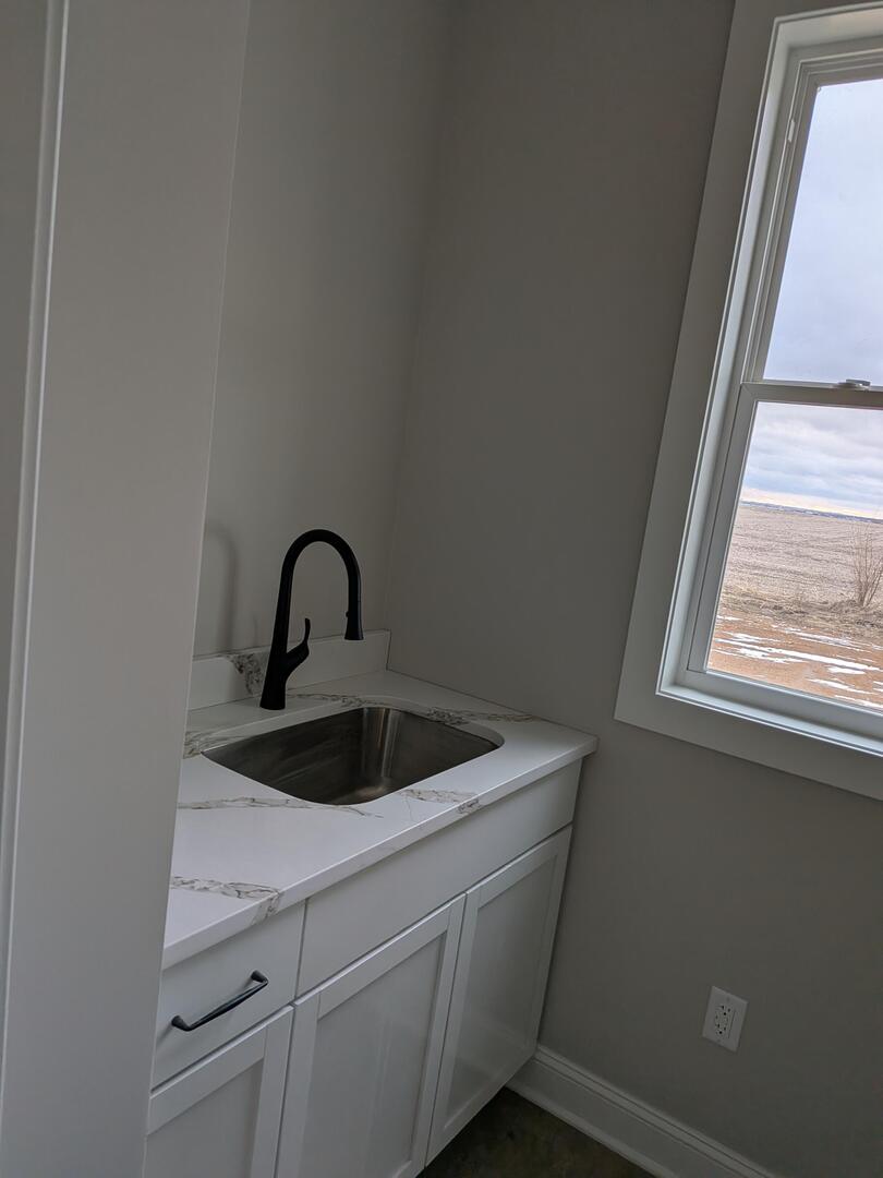 675 South Regulators Street Creston, IL 60113 - Photo 4 of 27 a close view of a sink and tap with window