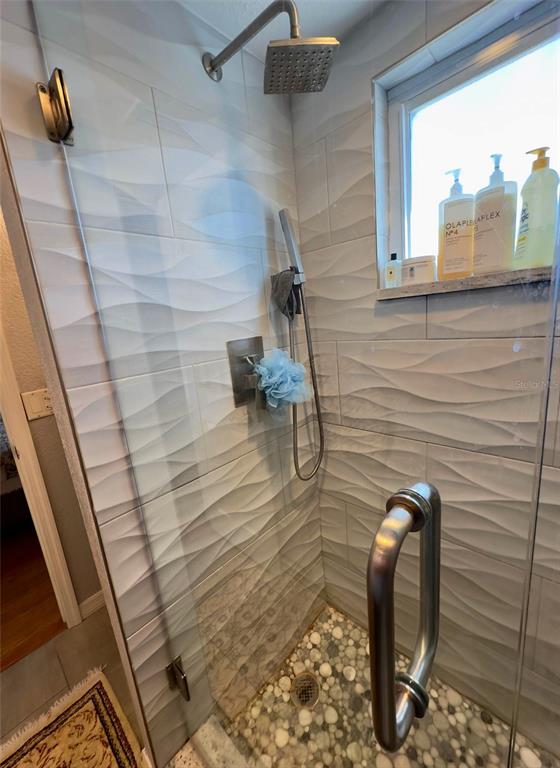 8911 Blind Pass Road, Unit 220 St. Pete Beach, FL 33706 - Photo 57 of 67 a bathroom with a shower