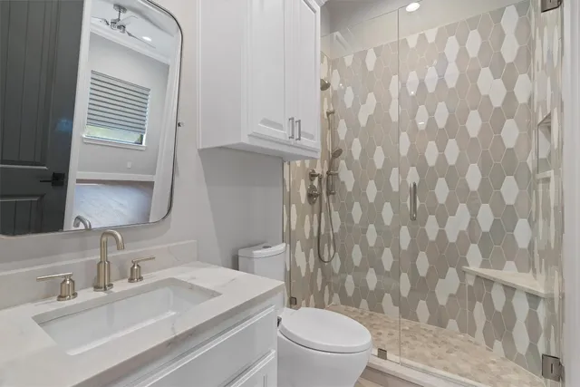 a bathroom with a sink toilet and shower