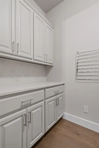 a kitchen with white cabinets and a sink