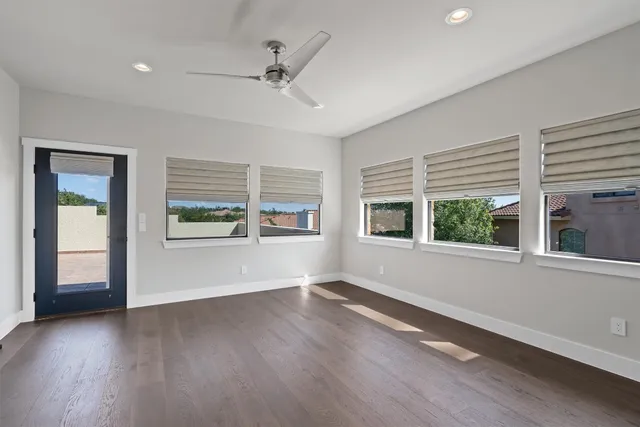 a view of wooden floor and windows in a room