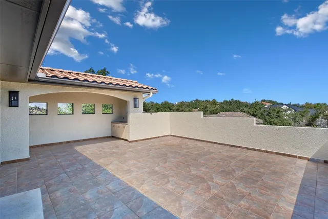 a view of a house with a yard and large tree
