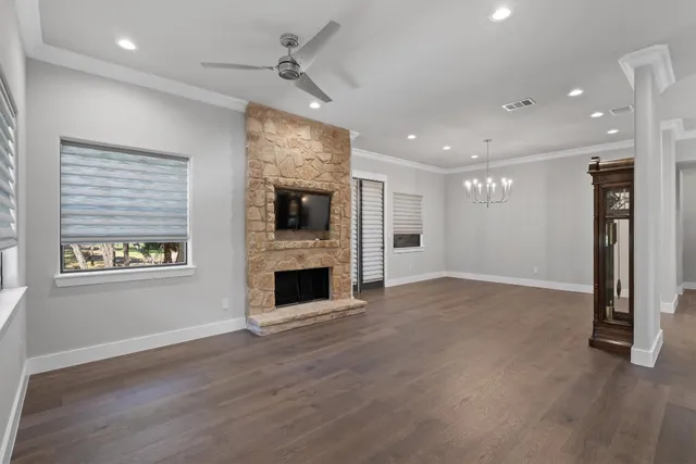 a view of an empty room with a fireplace and a window