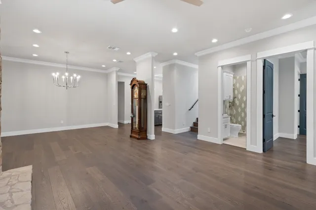 a view of an empty room with wooden floor and entryway