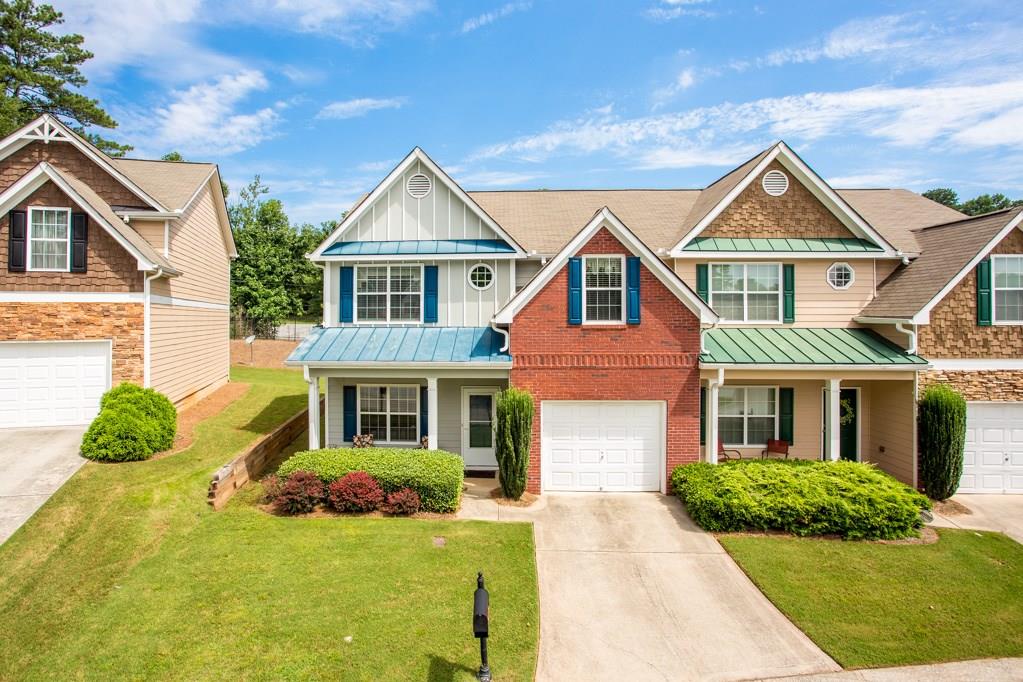 6161 Grovecrest Way Southwest Austell, GA 30168 - Photo 1 of 1 a front view of a house with yard