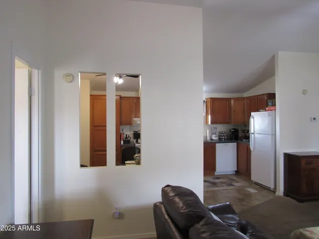 a living room with furniture and kitchen view