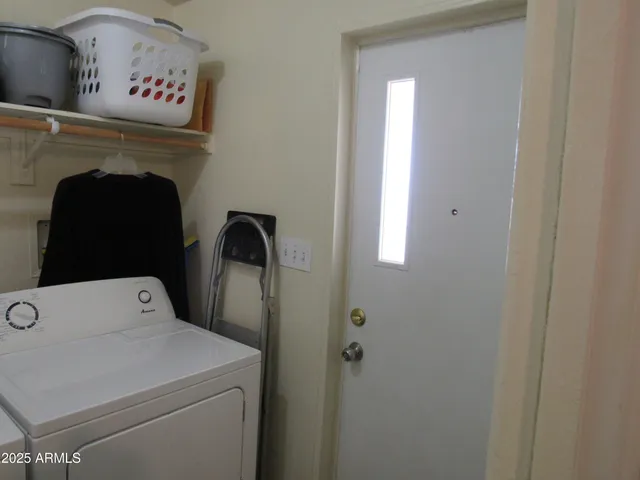 a close view of a utility room with dryer and washer