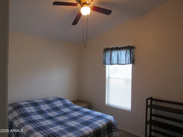 a bedroom with a bed and a window