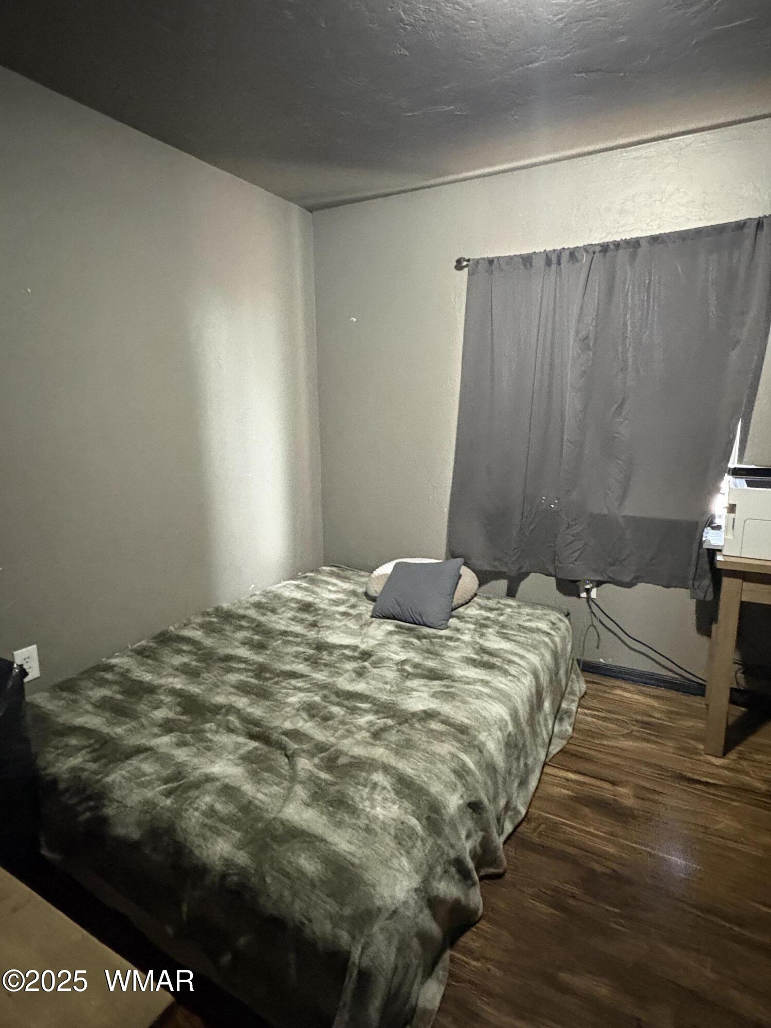 1 B County Road Concho, AZ 85924 - Photo 13 of 21 a bedroom with a bed and a wooden floor