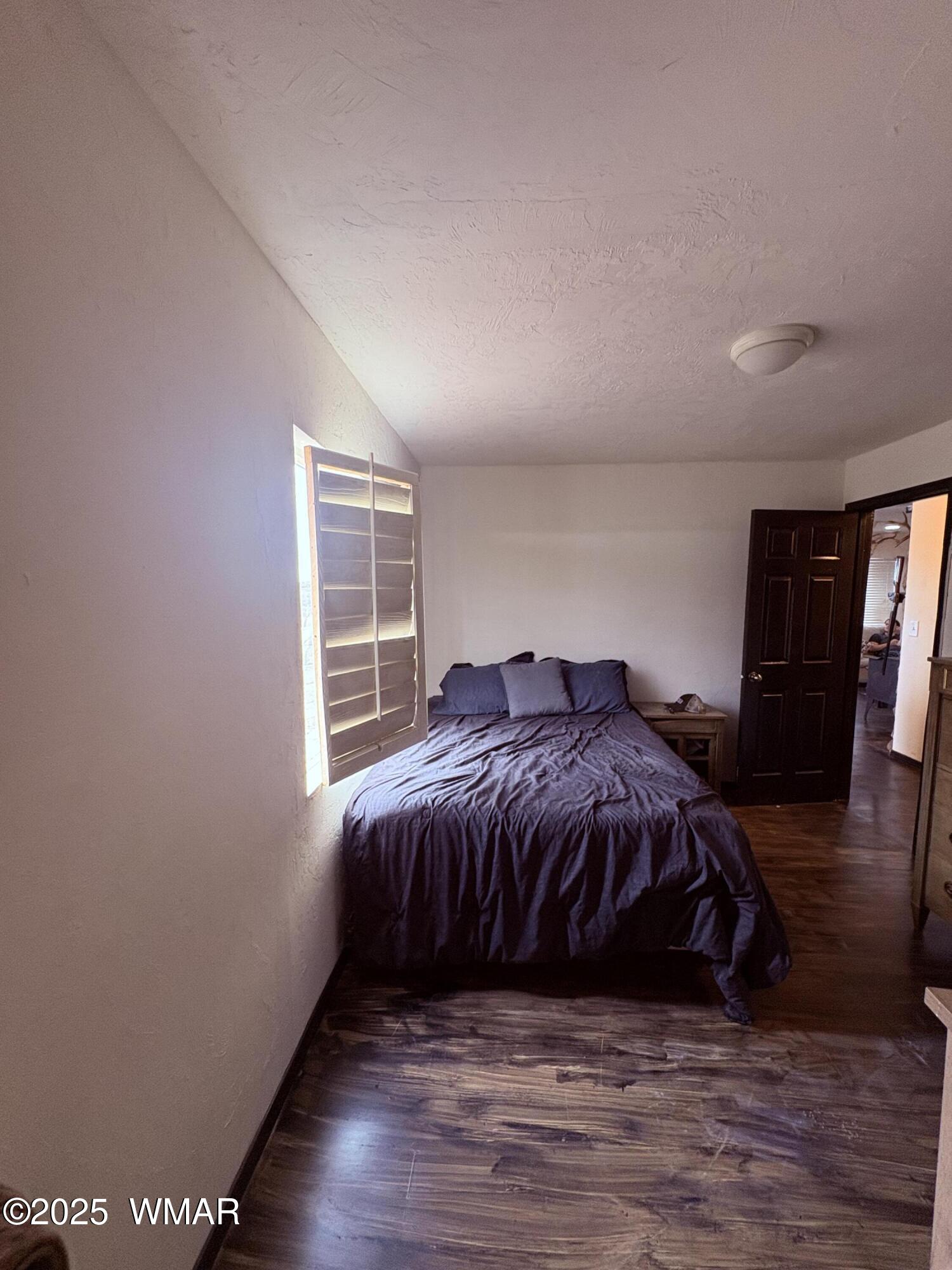 1 B County Road Concho, AZ 85924 - Photo 14 of 21 a bed sitting in a spacious bedroom next to a window
