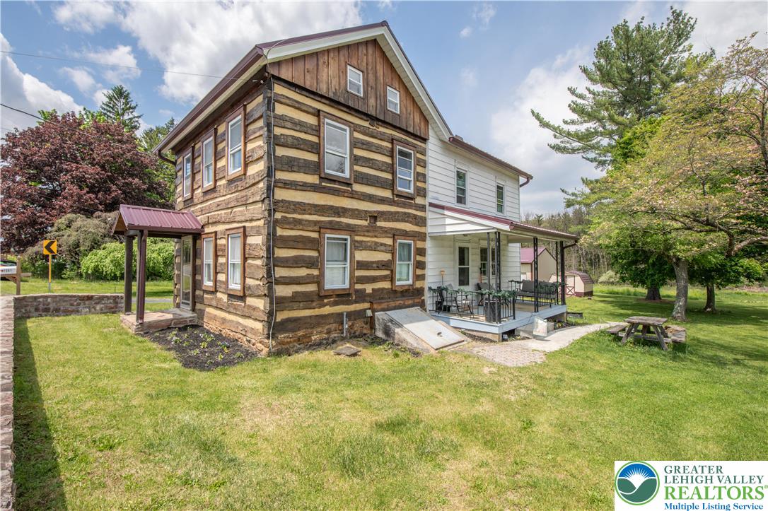 a view of a house with backyard porch and sitting area