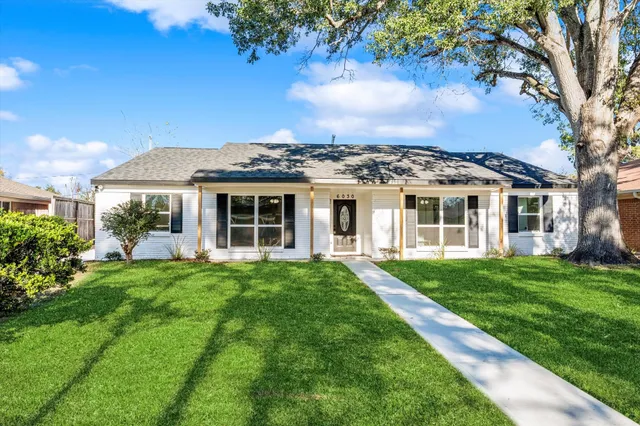 a view of a house with a backyard
