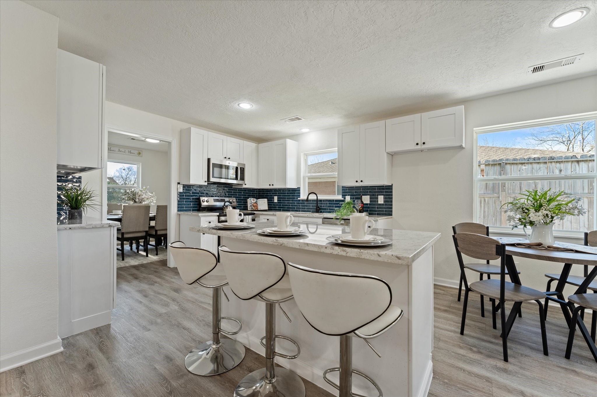 6030 Beaudry Drive Houston, TX 77035 - Photo 14 of 45 a kitchen with granite countertop stainless steel appliances a table and chairs in it