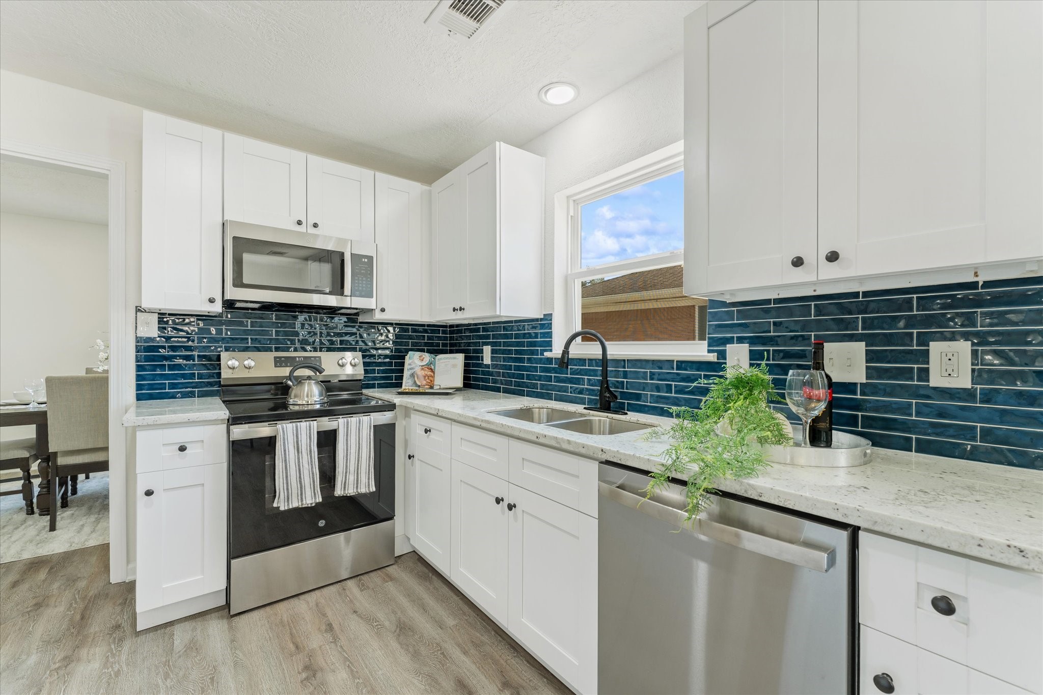 6030 Beaudry Drive Houston, TX 77035 - Photo 21 of 45 a kitchen with appliances a sink and cabinets