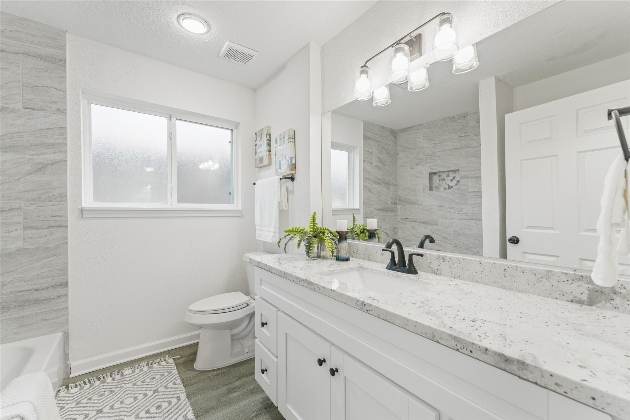 6030 Beaudry Drive Houston, TX 77035 - Photo 32 of 45 a bathroom with a double vanity sink toilet and a mirror