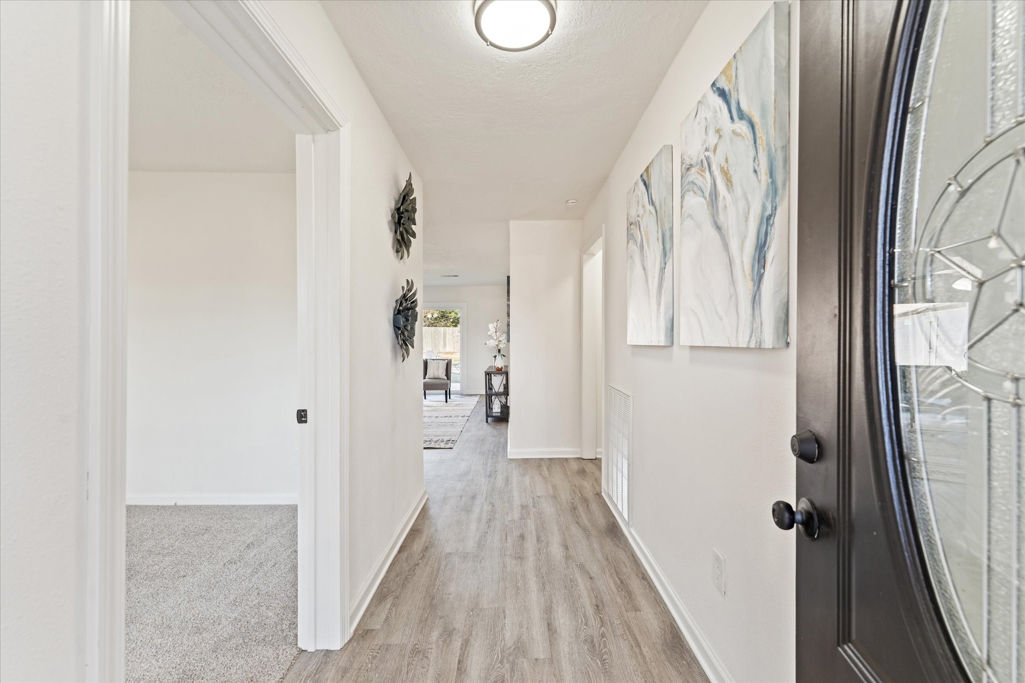 6030 Beaudry Drive Houston, TX 77035 - Photo 6 of 45 a view of a hallway with wooden floor and staircase