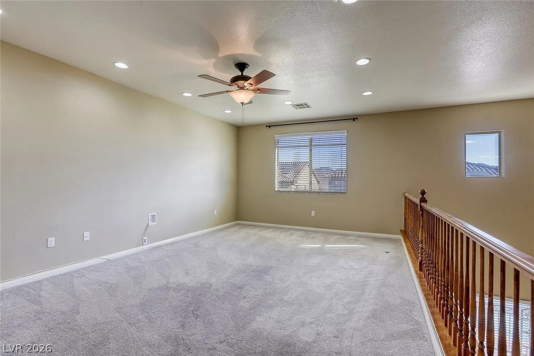692 Blue Crystal Creek Road Henderson, NV 89002 - Photo 15 of 29 Empty room with carpet flooring, ceiling fan, recessed lighting, and a textured ceiling