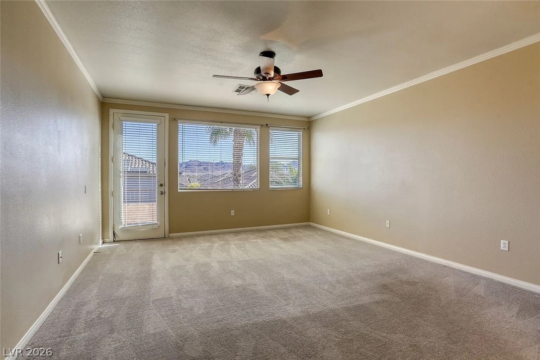 692 Blue Crystal Creek Road Henderson, NV 89002 - Photo 20 of 29 Empty room featuring a ceiling fan, ornamental molding, and carpet floors