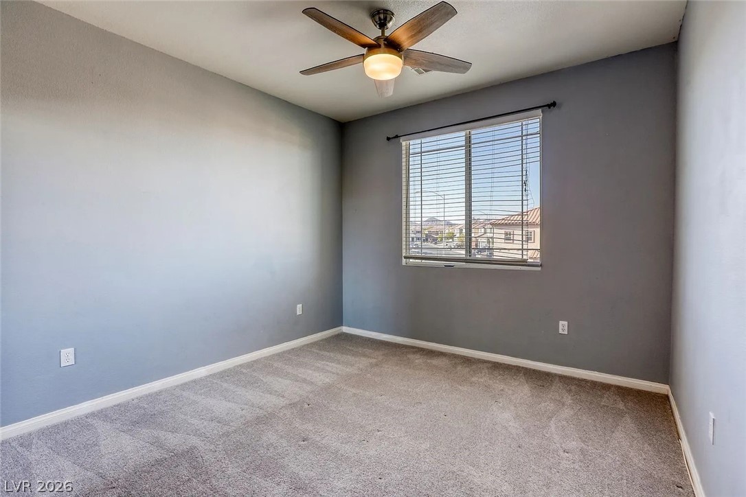 692 Blue Crystal Creek Road Henderson, NV 89002 - Photo 7 of 29 Carpeted empty room with a ceiling fan and baseboards