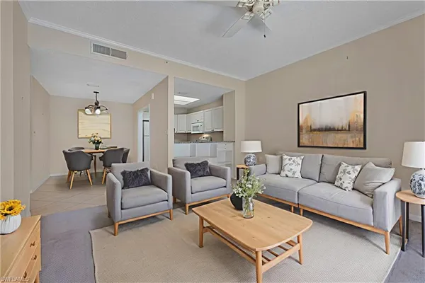 a living room with furniture and a chandelier