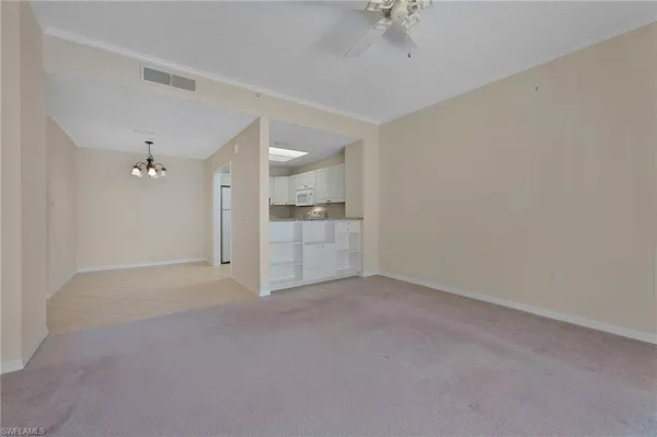 a view of a kitchen with a sink and a refrigerator