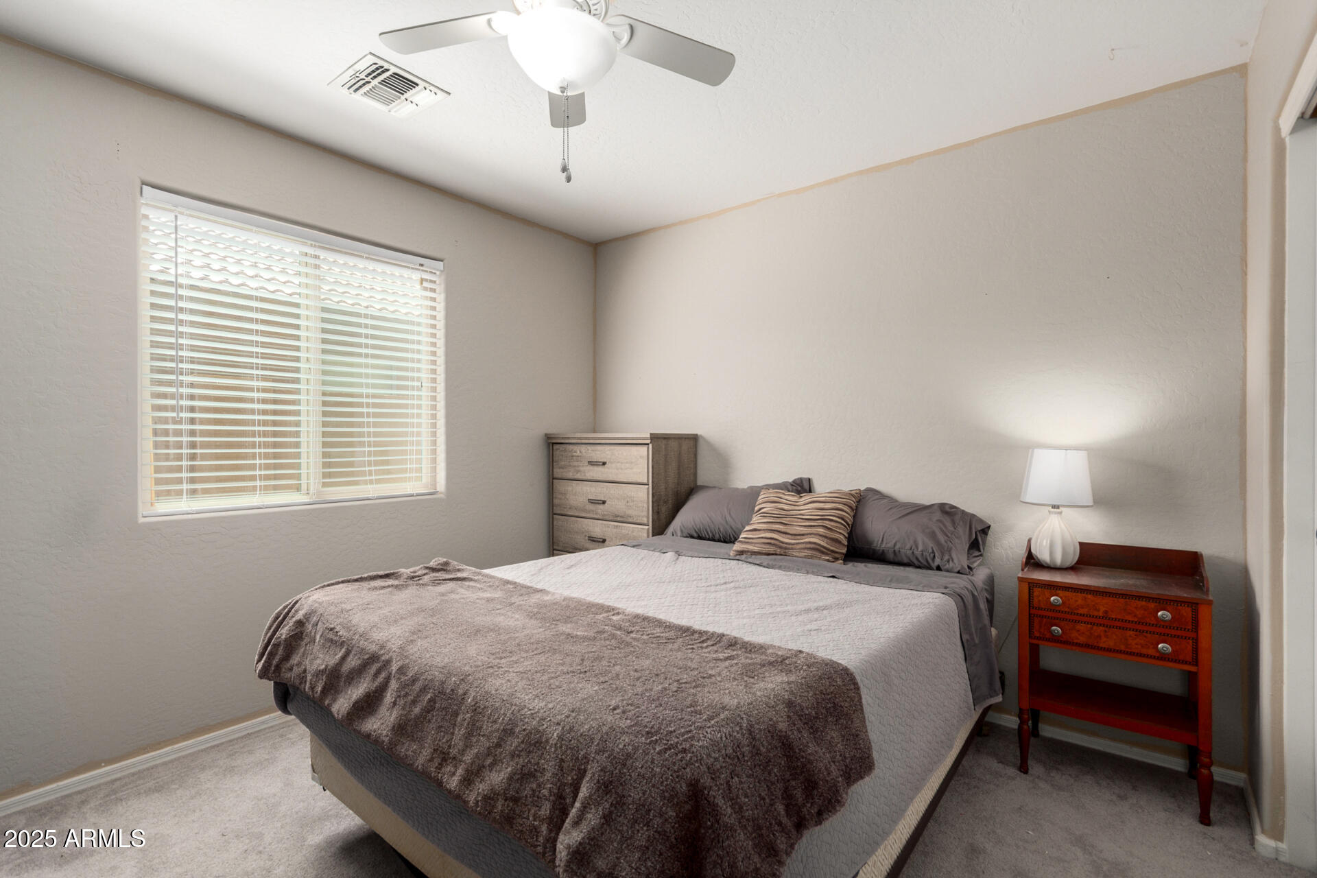 1634 East Harwell Road Phoenix, AZ 85042 - Photo 23 of 44 a spacious bedroom with a bed and a window