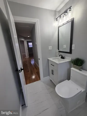 a bathroom with a sink a toilet a mirror and vanity