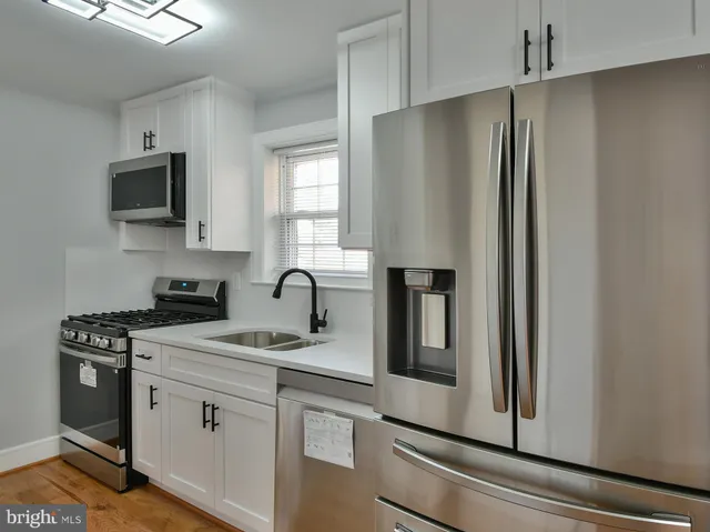a stove sitting inside of a kitchen with granite countertop