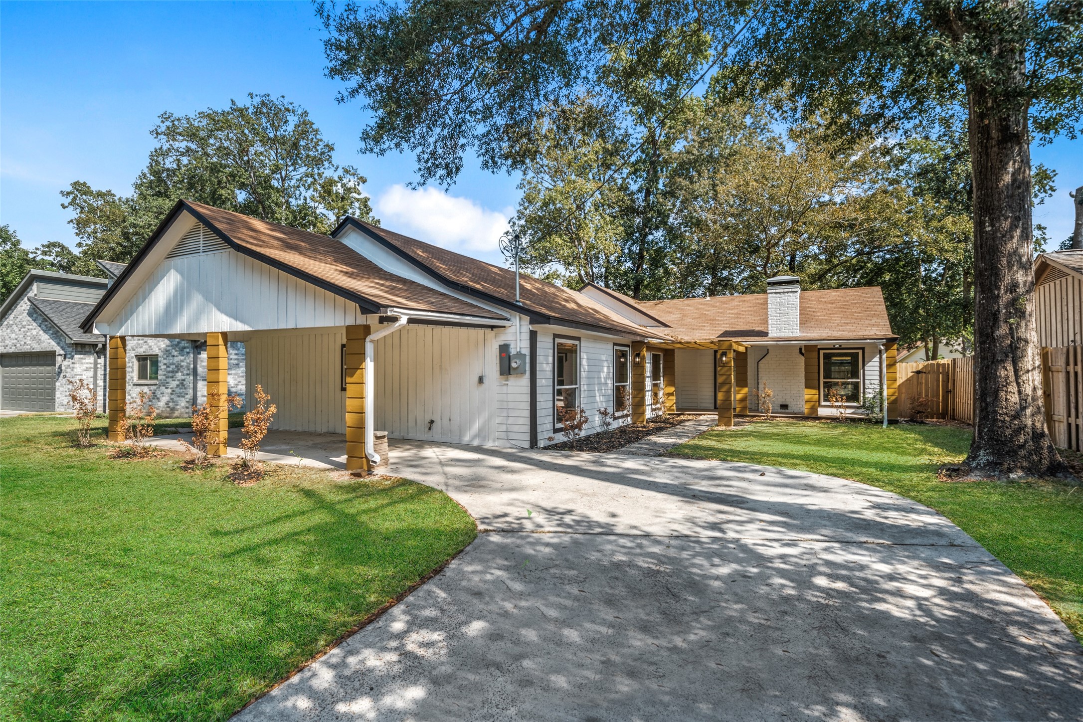 a front view of a house with a garden and trees