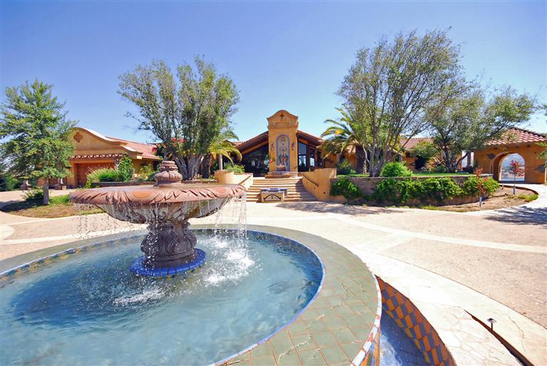 This home embodies the romance of Old World Europe beginning with the approach and continuing throughout the interior.  Upon arrival one passes through beautiful privacy gates & up the driveway to the motorcourt with central fountain.  With views of the lake peeking your interest, you will be drawn in to this amazing estate.