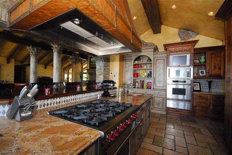 4678 Millerton Road Friant, CA 93626 - Photo 33 of 86 Gourmet Kitchen ~ There is a 6 burner gas Wolf range/oven and a custom designed and handpainted built-in hutch.