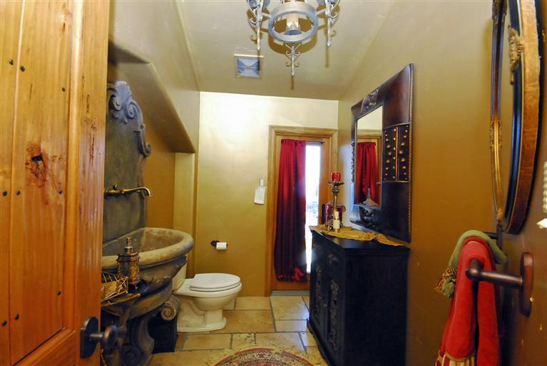 4678 Millerton Road Friant, CA 93626 - Photo 34 of 86 Guest Bath/Powder Room ~ This room provides a French door for back yard access and a gorgeous stone wall fountain basin.