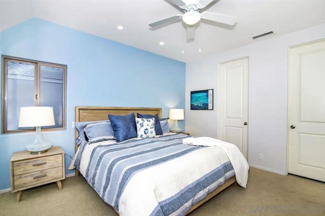 a bedroom with a bed and a lamp