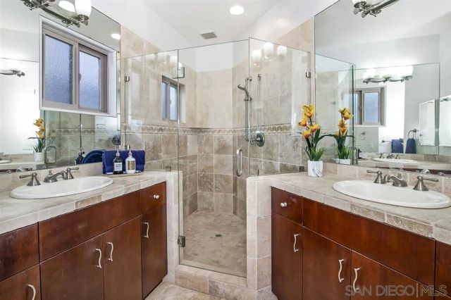 a bathroom with a granite countertop sink mirror and double