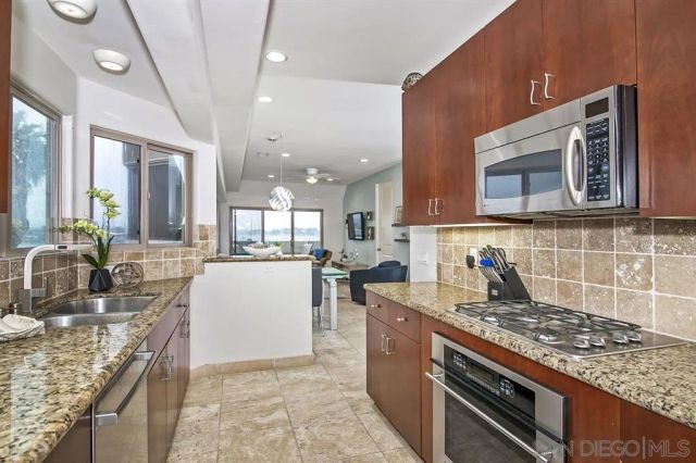 a kitchen with stove and cabinets
