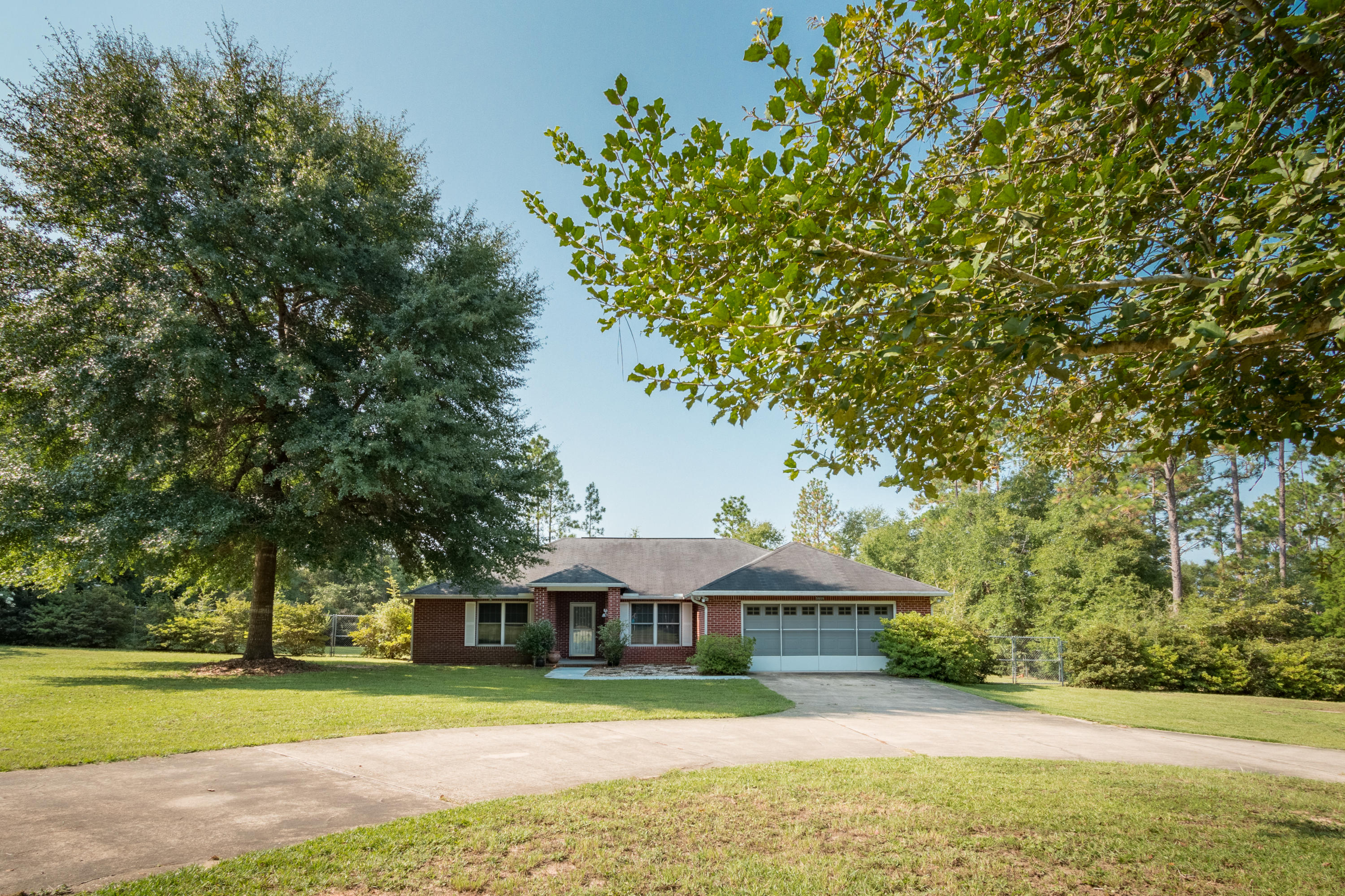 5909 Old Bethel Road Crestview, FL 32536 - Photo 1 of 47 a front view of a house with a yard