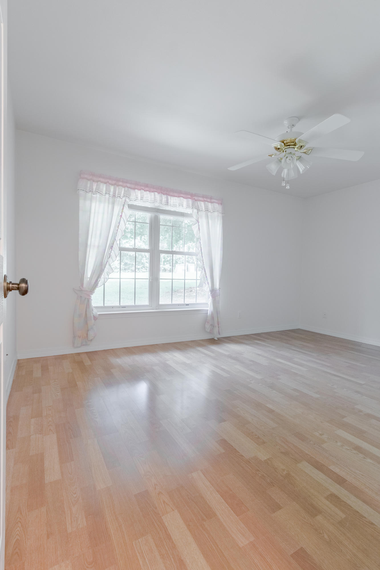 5909 Old Bethel Road Crestview, FL 32536 - Photo 33 of 47 wooden floor in an empty room with a window