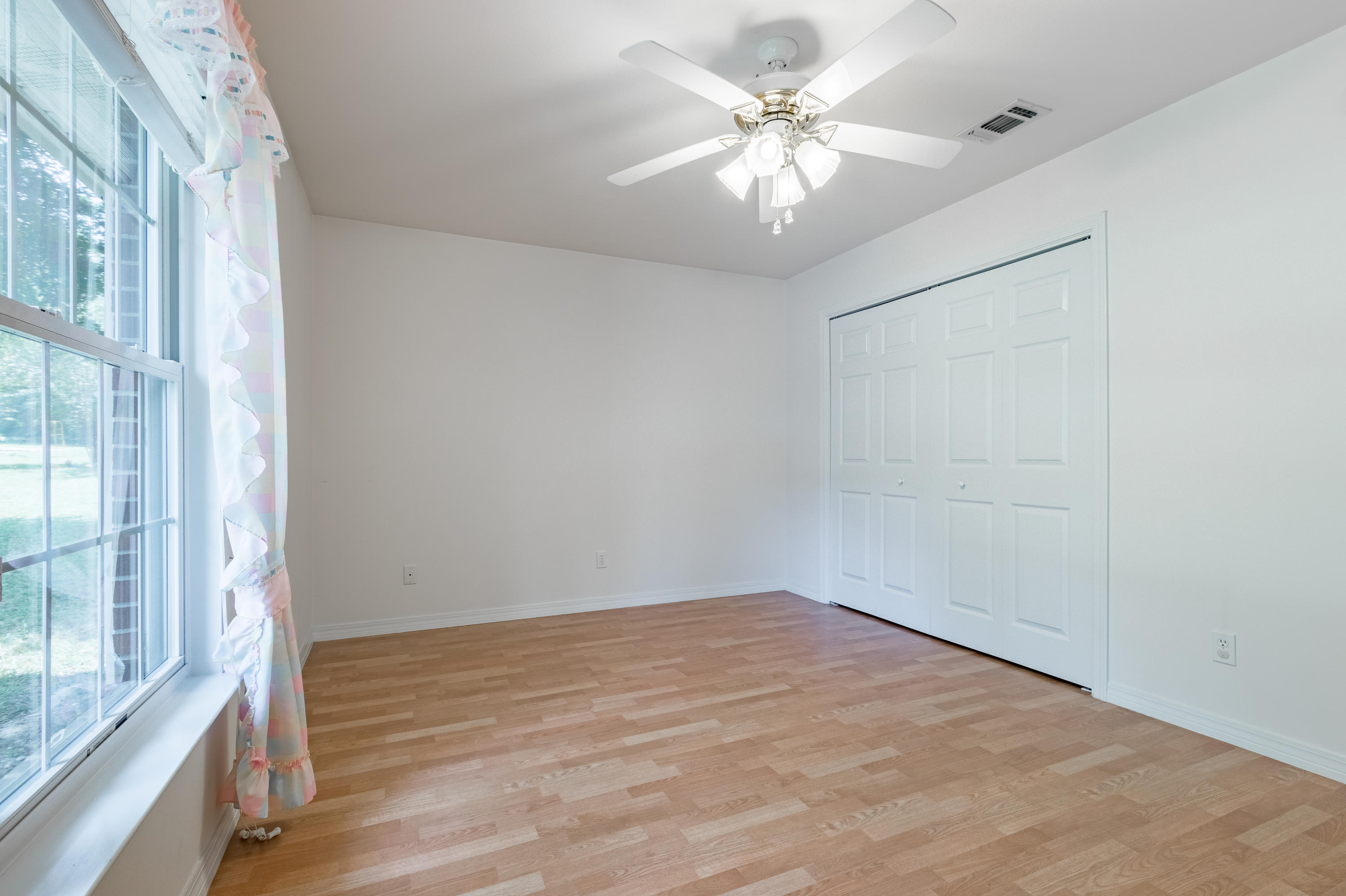 5909 Old Bethel Road Crestview, FL 32536 - Photo 34 of 47 wooden floor in an empty room with a window