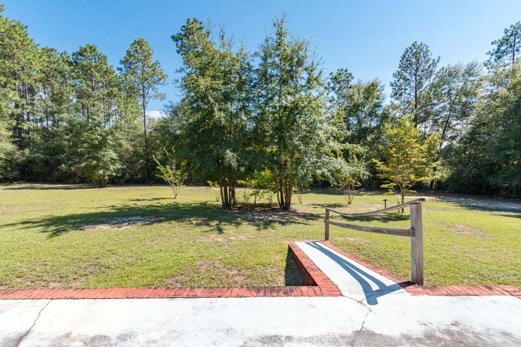 5909 Old Bethel Road Crestview, FL 32536 - Photo 46 of 47 a view of a yard with wooden deck