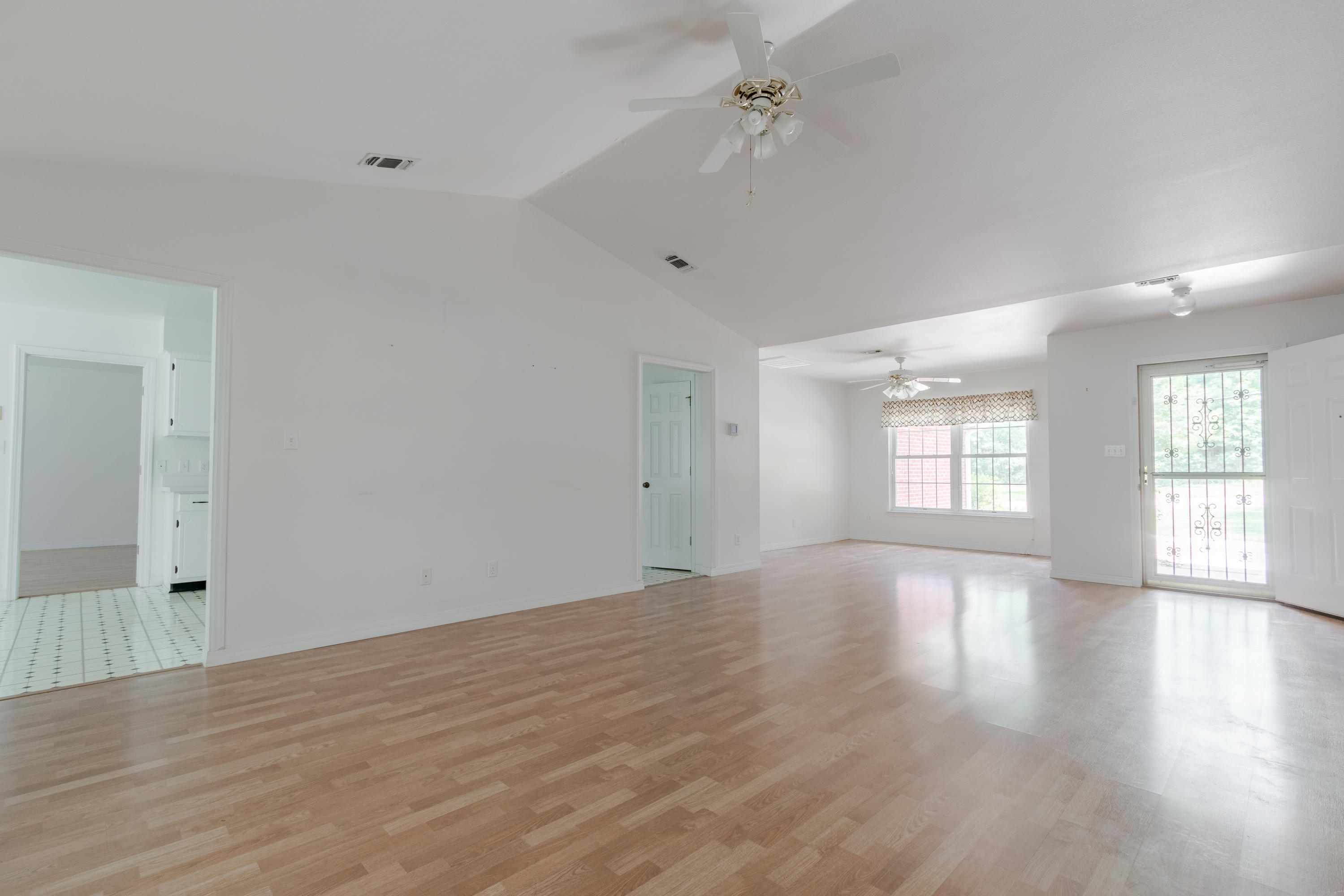 5909 Old Bethel Road Crestview, FL 32536 - Photo 9 of 47 wooden floor in an empty room with a window
