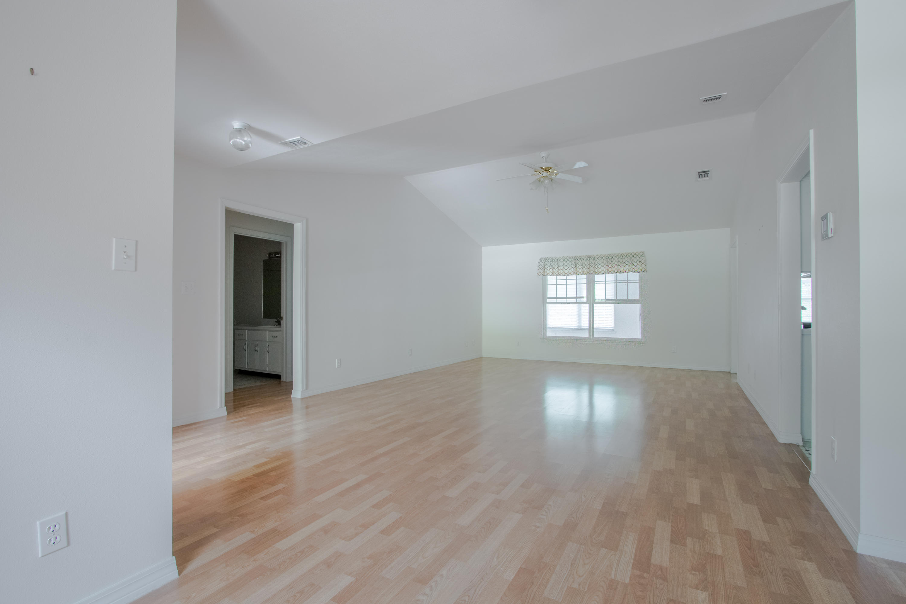 5909 Old Bethel Road Crestview, FL 32536 - Photo 10 of 47 wooden floor in an empty room with a window