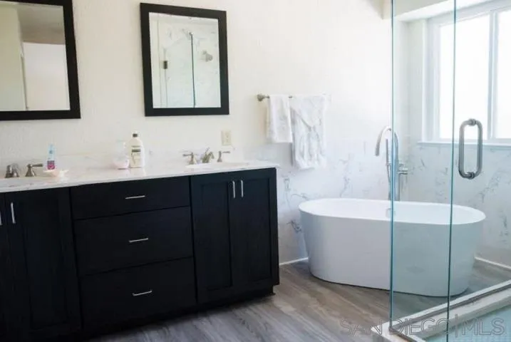 1615 Fuerte Ranch Road El Cajon, CA 92019 - Photo 5 of 17 a bathroom with a double vanity sink mirror and bathtub