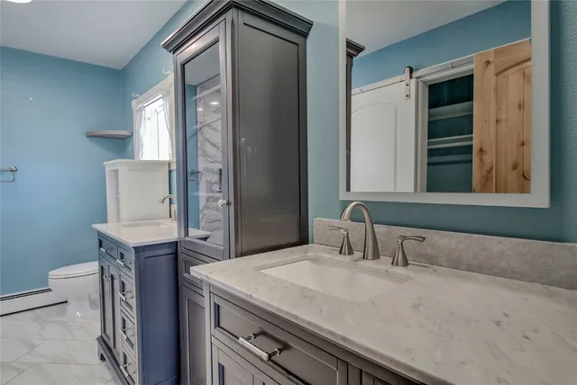 a bathroom with a sink a vanity and mirror