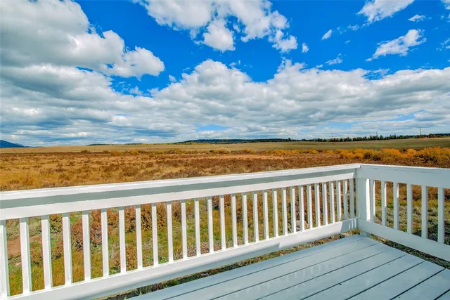 a view of a balcony with wooden floor