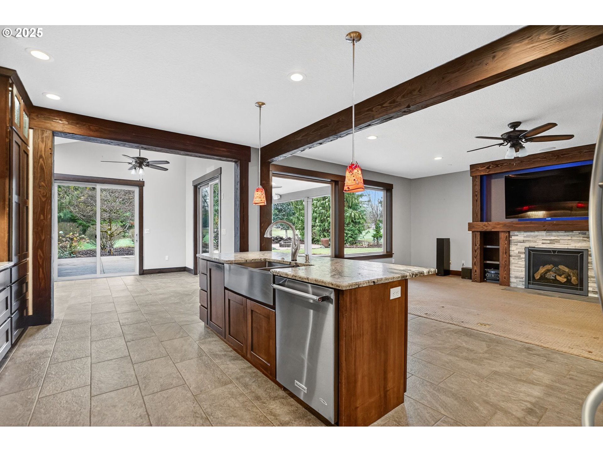 18740 South Upper Highland Road Beavercreek, OR 97004 - Photo 15 of 48 a kitchen with kitchen island granite countertop a stove and a view of living room